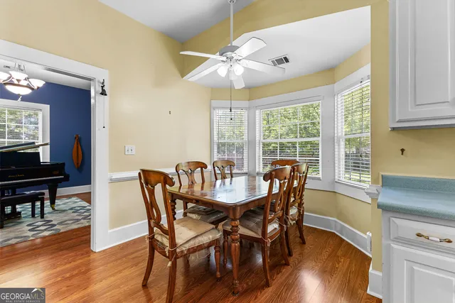 a kitchen with stainless steel appliances granite countertop a stove a sink and white cabinets