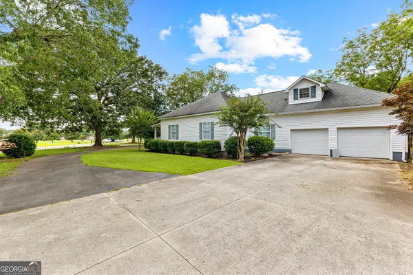 a view of a house with a yard and garage