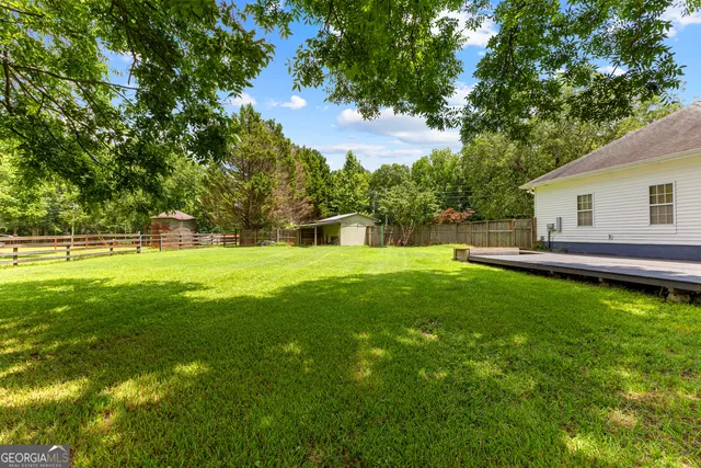 an aerial view of a house with a yard and lake view