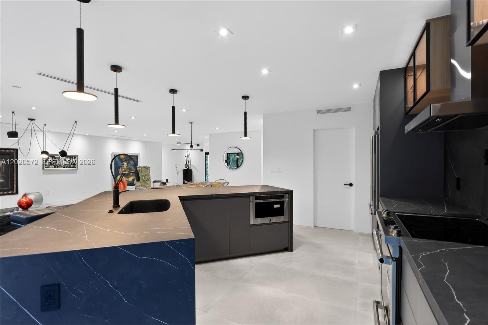 439 Hardee Road Coral Gables, FL 33146 - Photo 13 of 35 a kitchen with stainless steel appliances kitchen island granite countertop a sink dishwasher stove and cabinets