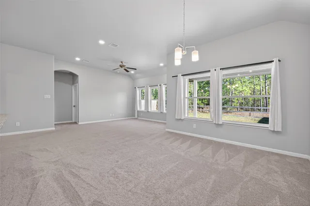 a kitchen with a refrigerator and a stove top oven