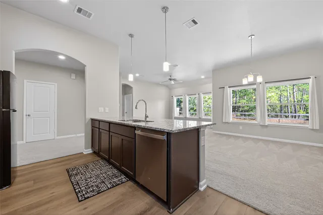 a kitchen with stainless steel appliances granite countertop a stove microwave and refrigerator