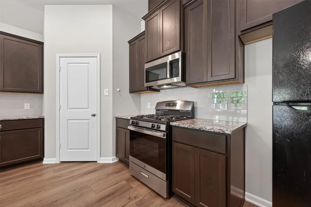 a spacious bedroom with a bed and a chair