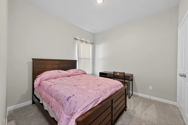 a bedroom with a bed and window