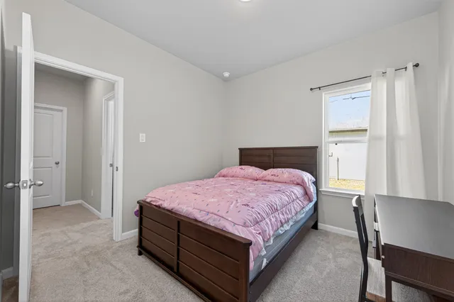 a bedroom with a bed and a ceiling fan