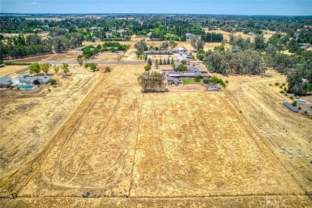 a living room with furniture kitchen view and a large window
