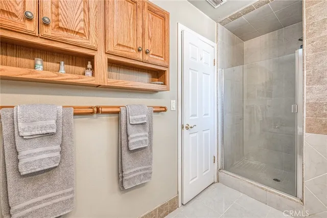a view of a patio with wooden floor next to a yard