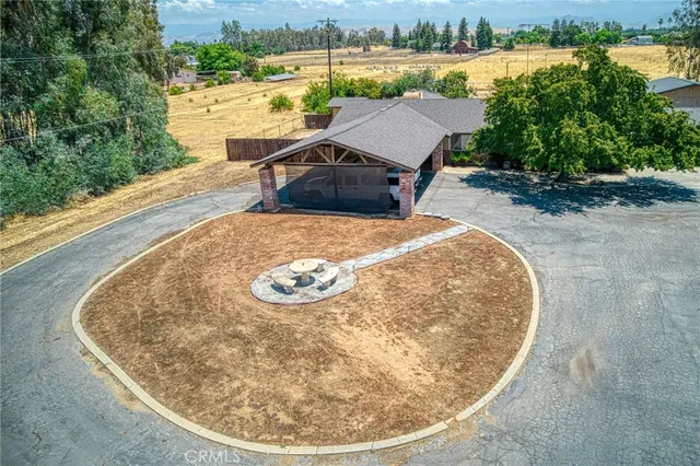 an aerial view of a house with swimming pool and garden