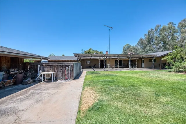 a front view of a house with a yard and trees