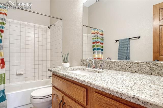 2690 Spaatz Road Monument, CO 80132 - Photo 25 of 50 Full bathroom featuring toilet, shower / bath combo with shower curtain, and vanity