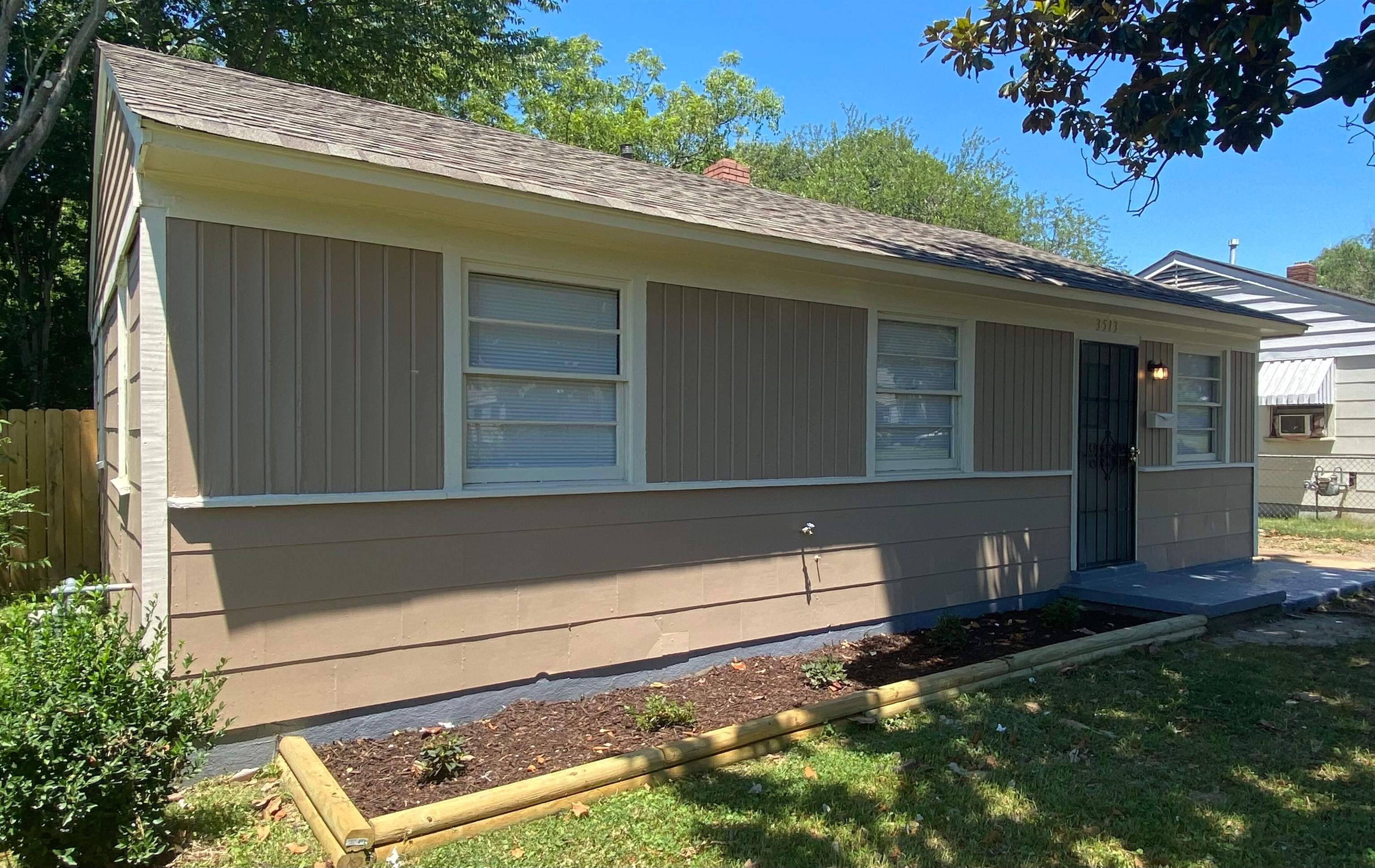 a view of house with backyard