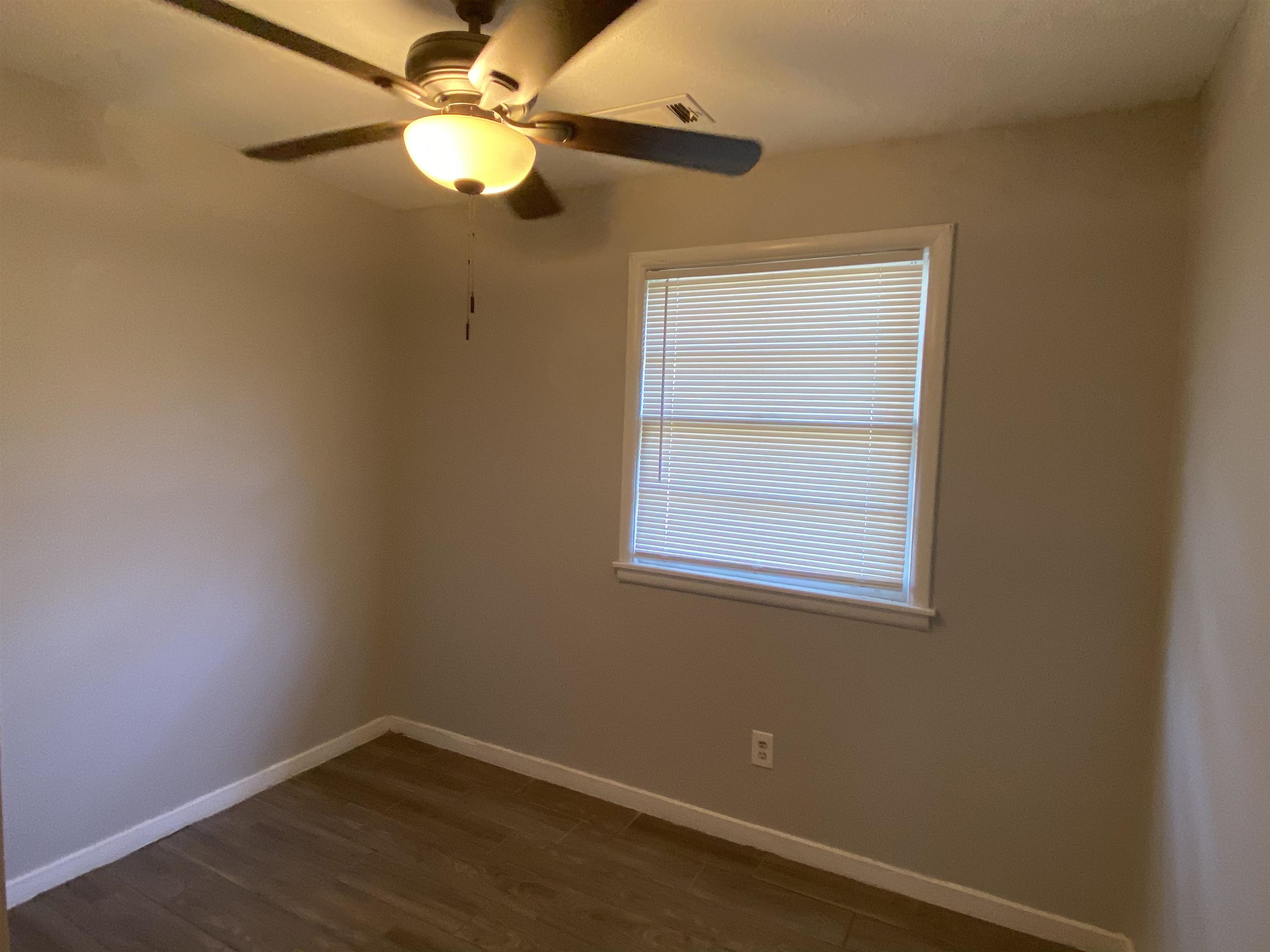 3513 Ashford Road Memphis, TN 38109 - Photo 4 of 21 an empty room with a window and a fan