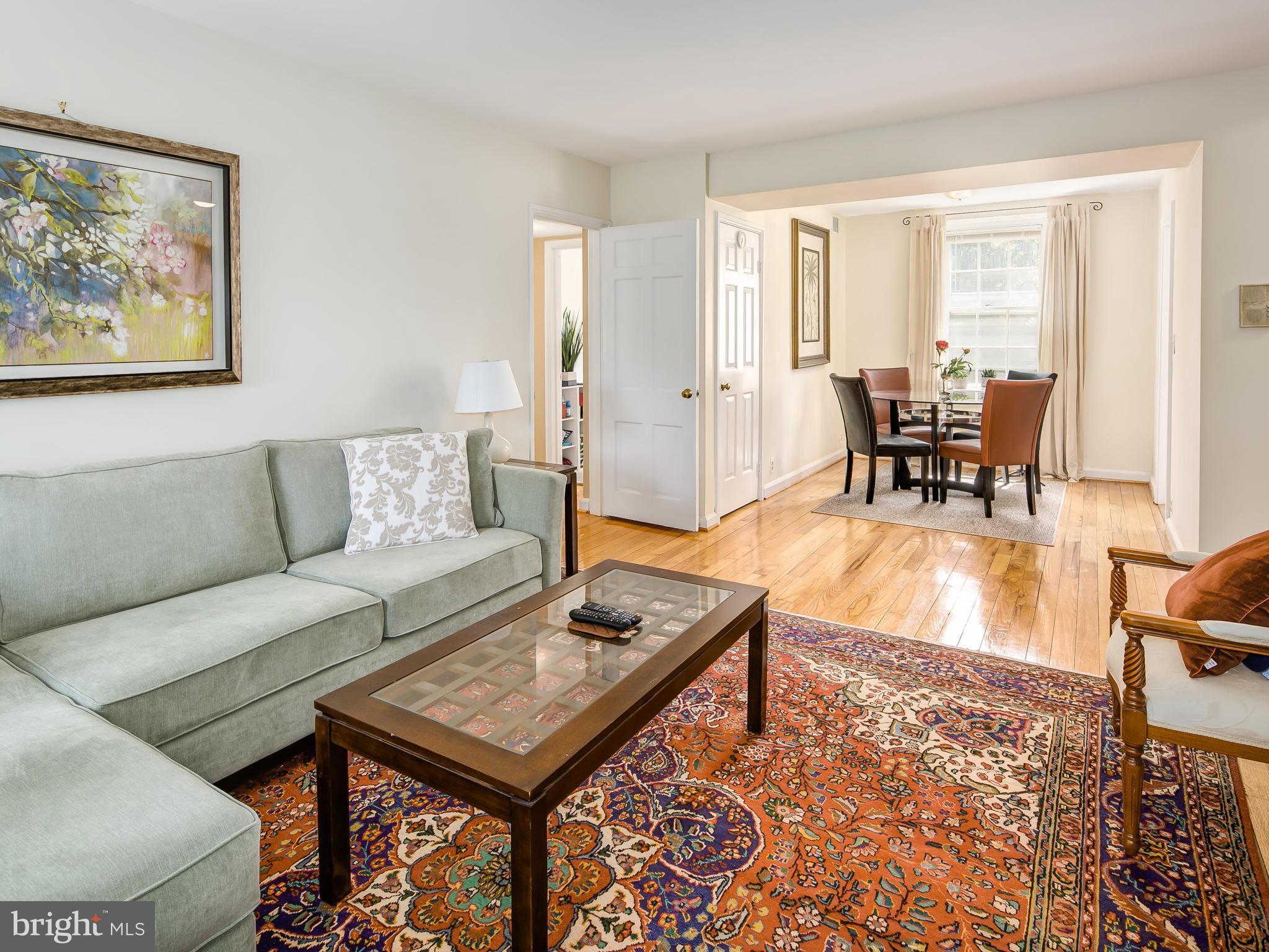 3851 Porter Street Northwest, Unit D280 Washington, DC 20016 - Photo 1 of 22 a living room with furniture and wooden floor
