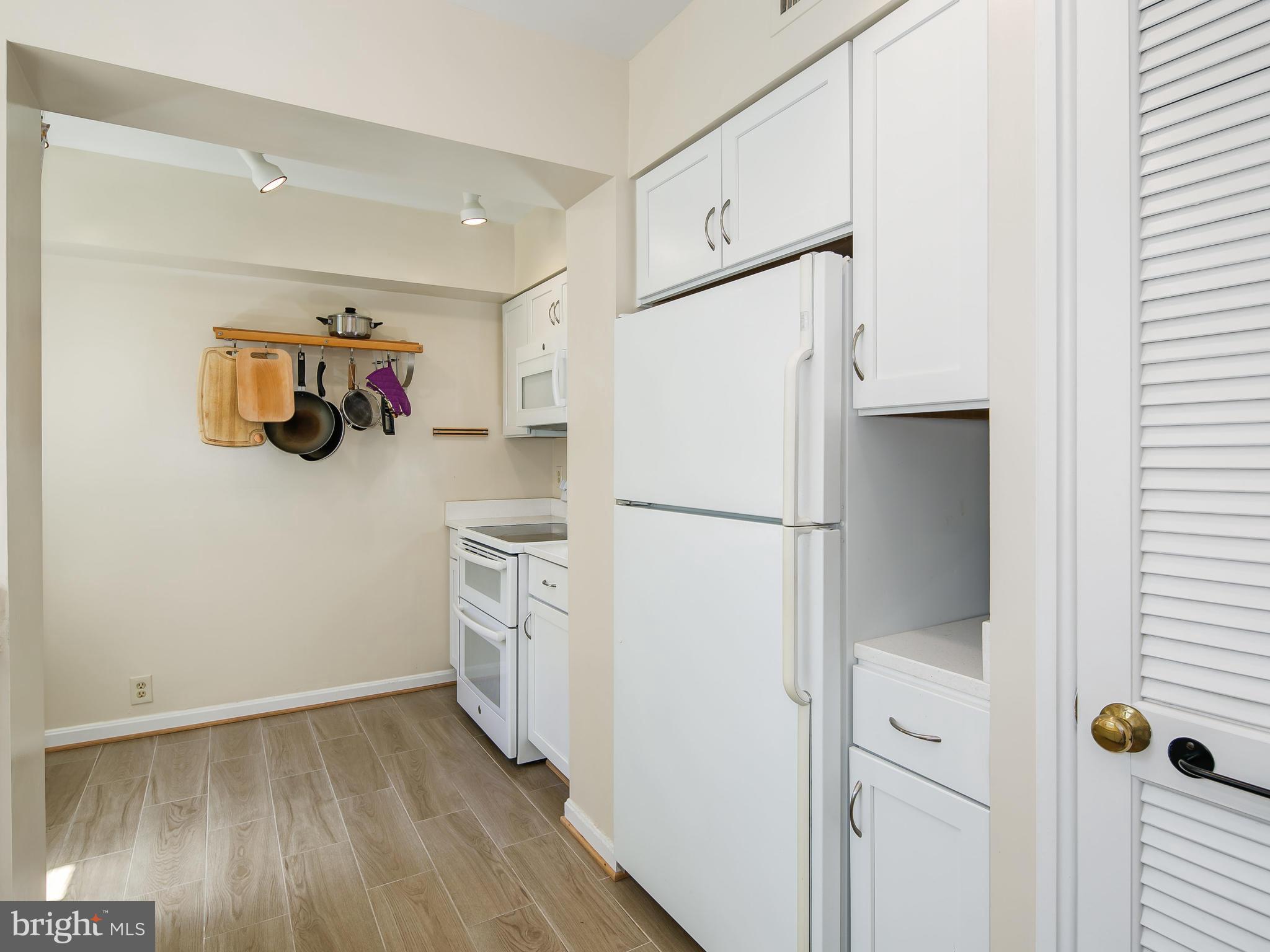 3851 Porter Street Northwest, Unit D280 Washington, DC 20016 - Photo 13 of 22 a white refrigerator freezer sitting inside of a kitchen