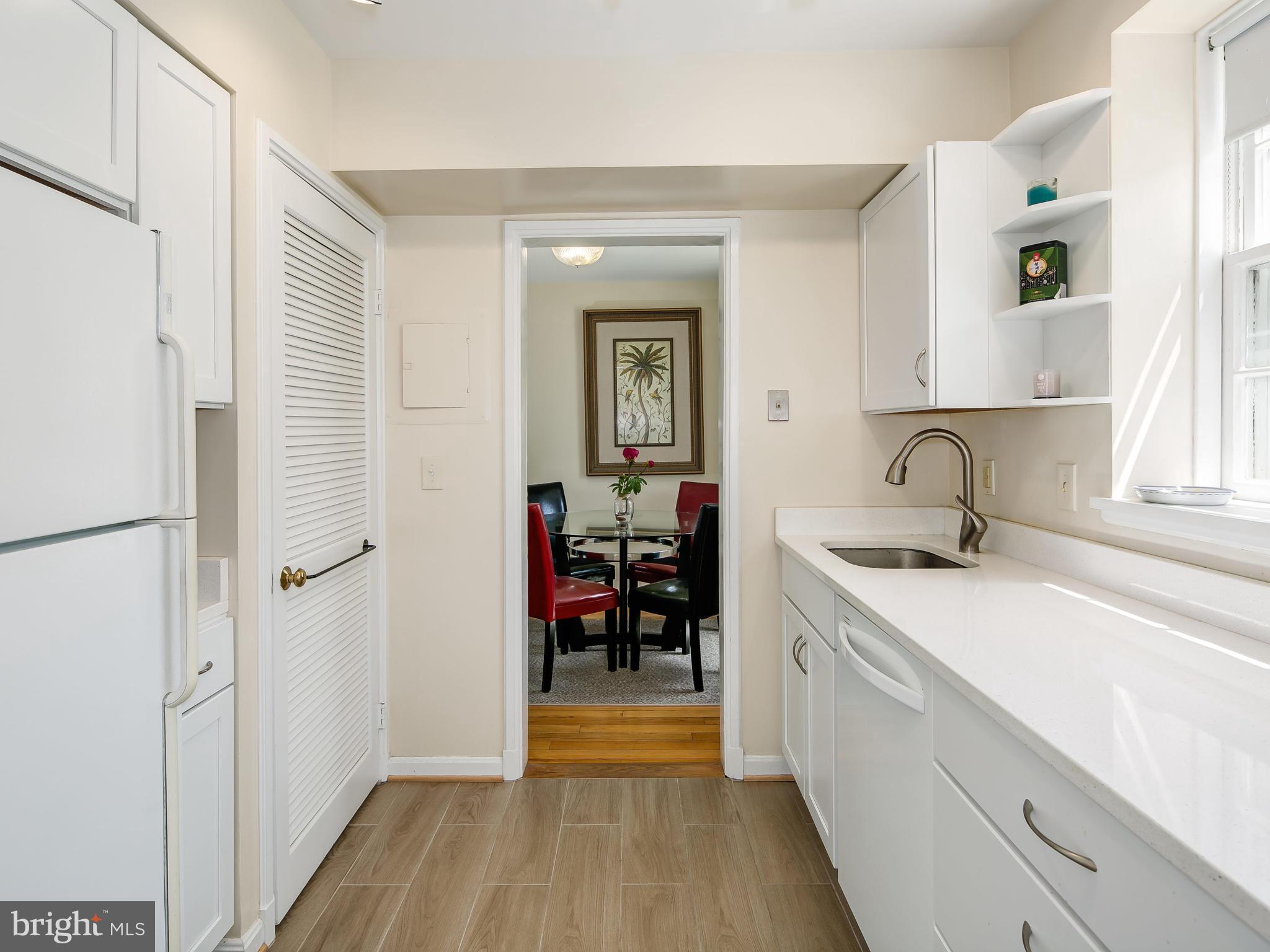 3851 Porter Street Northwest, Unit D280 Washington, DC 20016 - Photo 16 of 22 a kitchen with a sink and a refrigerator