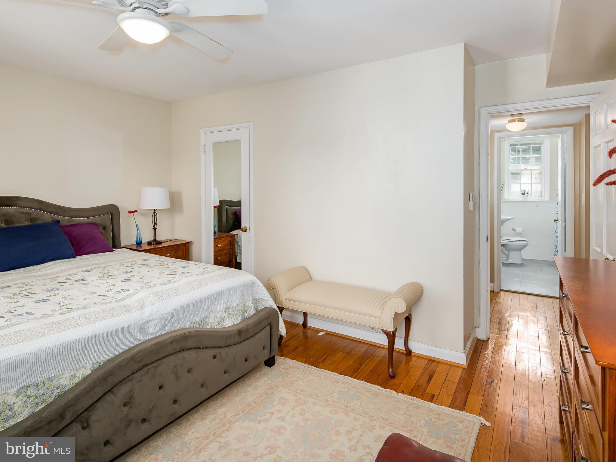 3851 Porter Street Northwest, Unit D280 Washington, DC 20016 - Photo 17 of 22 a bedroom with a bed and wooden floor