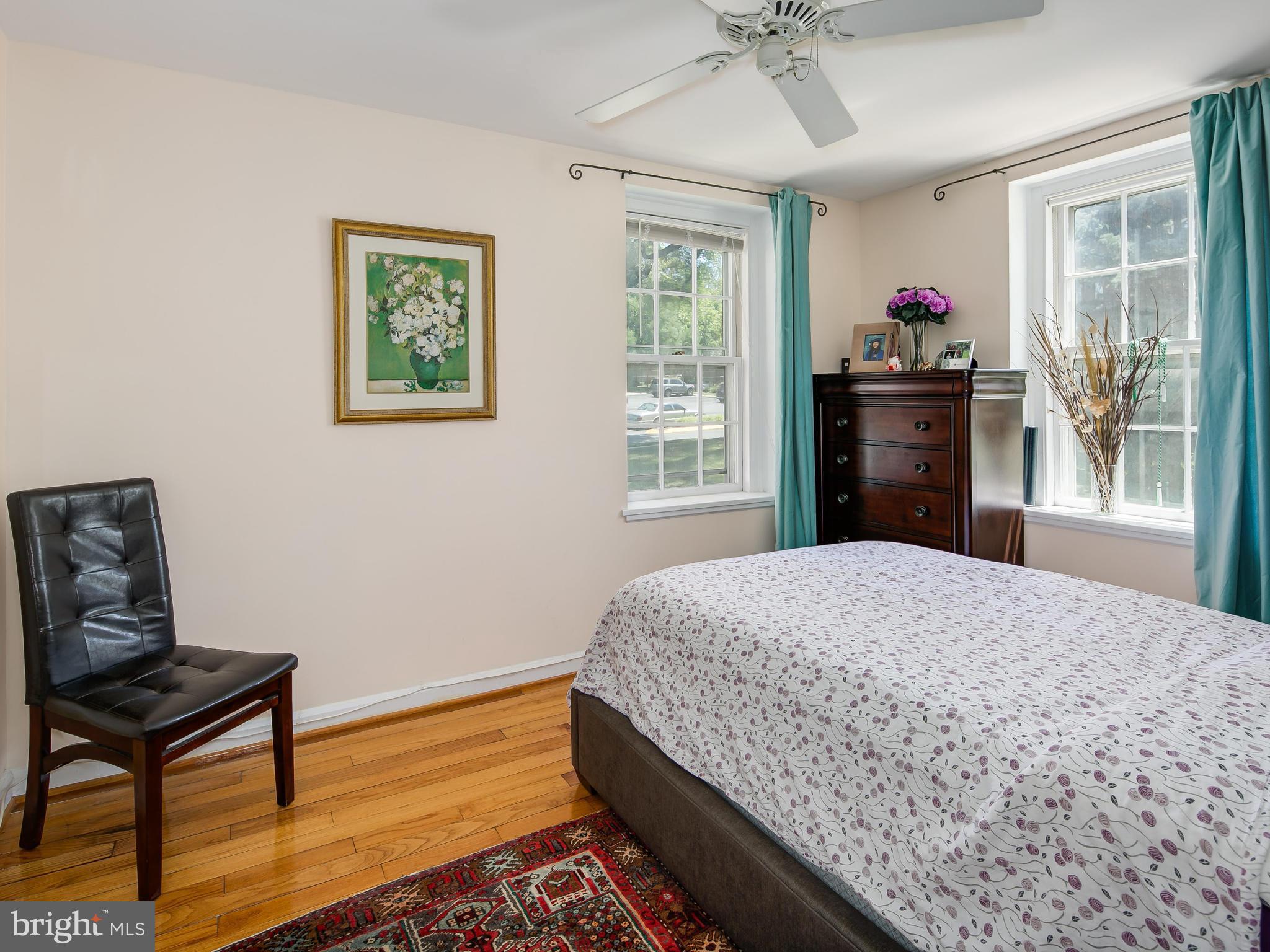 3851 Porter Street Northwest, Unit D280 Washington, DC 20016 - Photo 18 of 22 a bedroom with a bed and wooden floor
