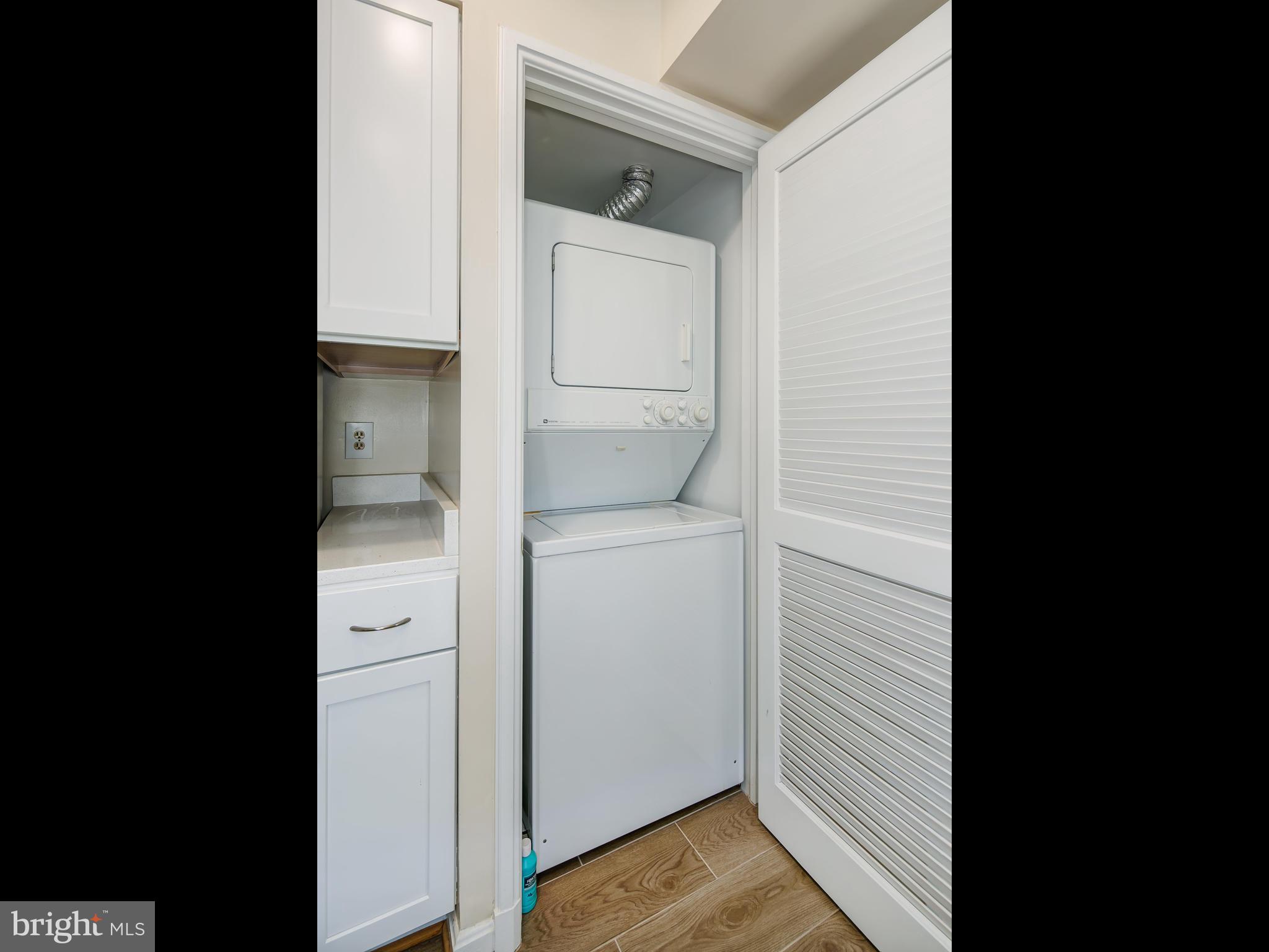 3851 Porter Street Northwest, Unit D280 Washington, DC 20016 - Photo 20 of 22 a view of hallway with washer and dryer