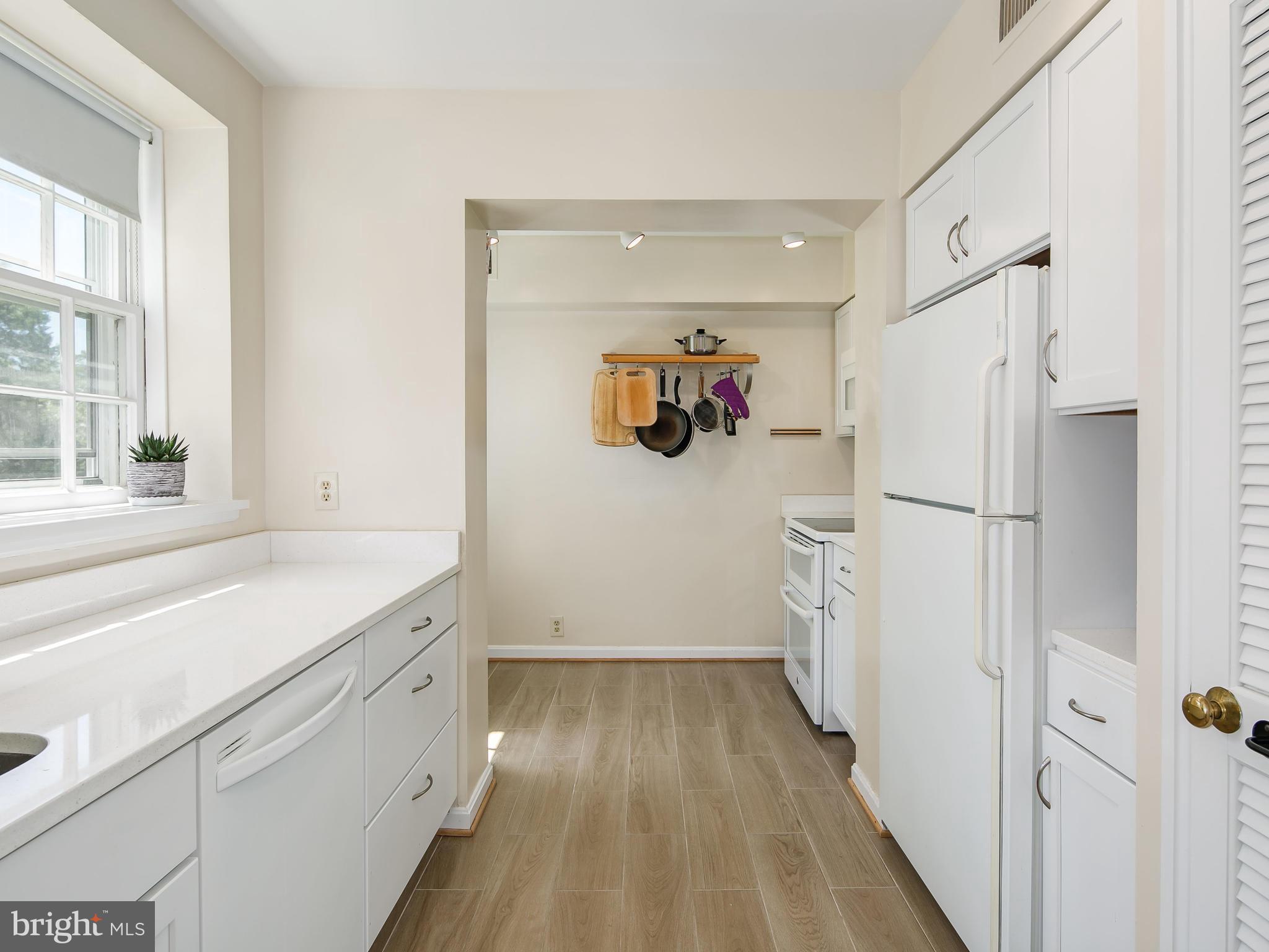3851 Porter Street Northwest, Unit D280 Washington, DC 20016 - Photo 3 of 22 a kitchen with a refrigerator and a sink