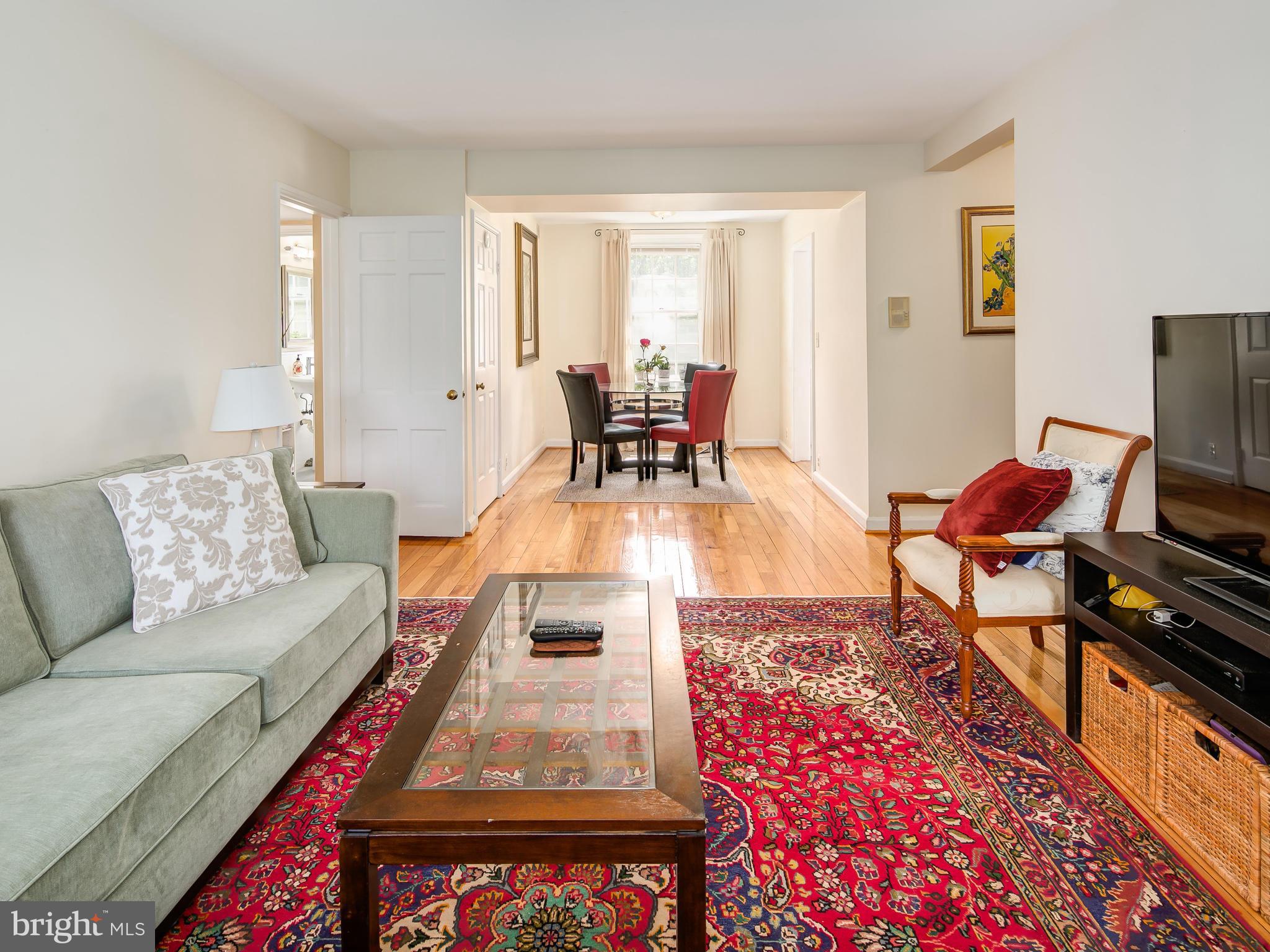 3851 Porter Street Northwest, Unit D280 Washington, DC 20016 - Photo 8 of 22 a living room with furniture and a flat screen tv