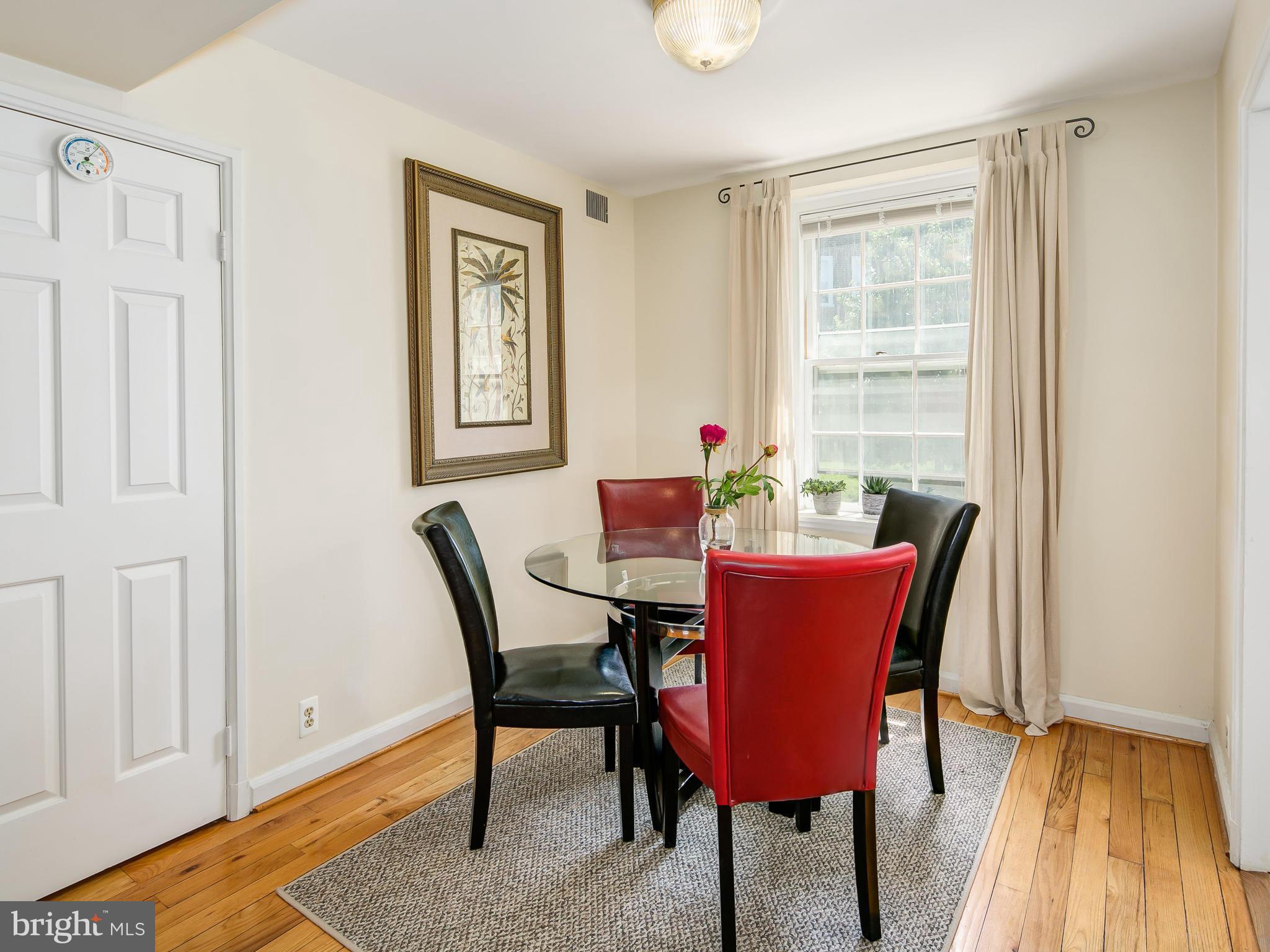 3851 Porter Street Northwest, Unit D280 Washington, DC 20016 - Photo 9 of 22 a dining room with furniture and wooden floor