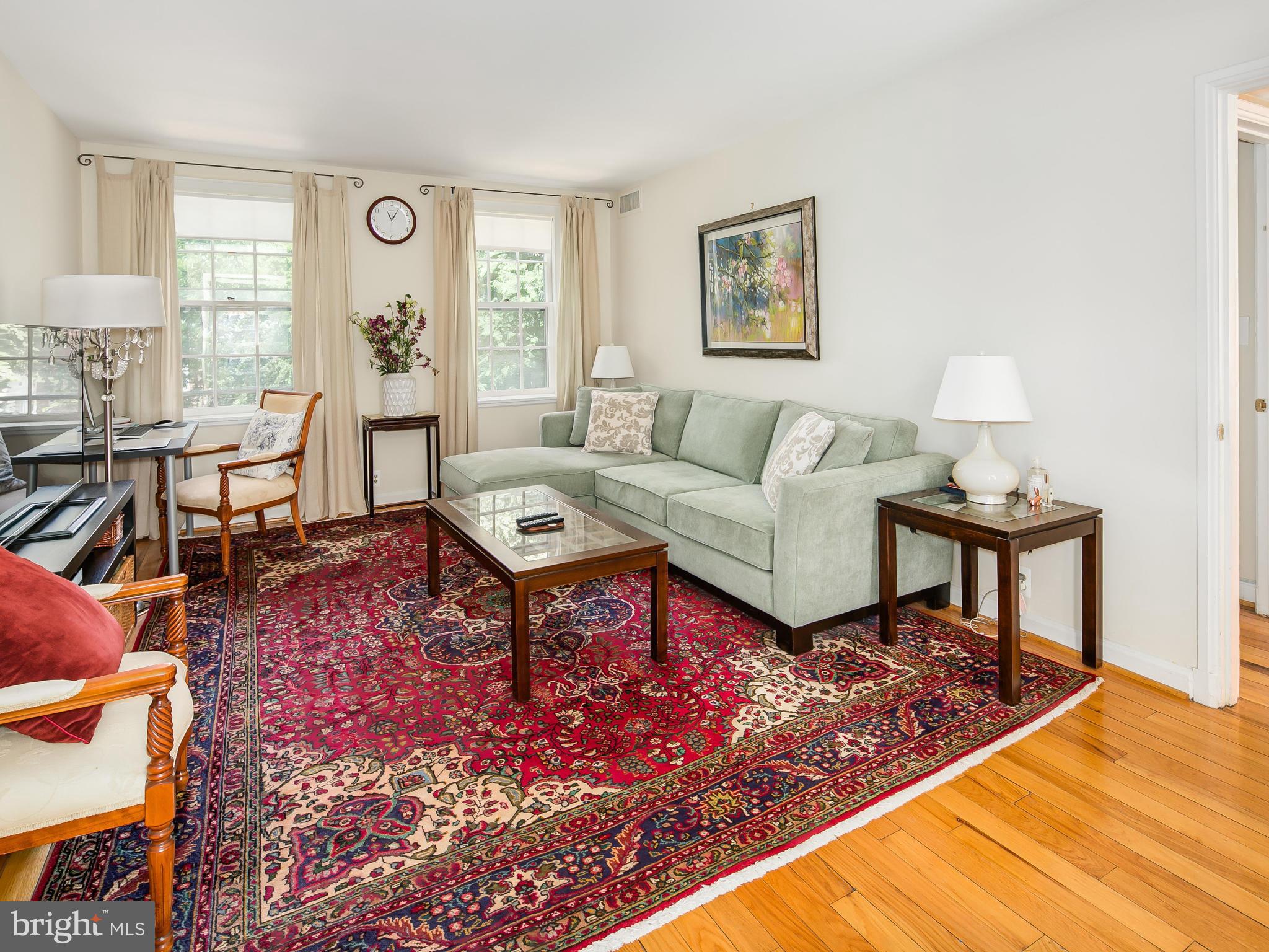 3851 Porter Street Northwest, Unit D280 Washington, DC 20016 - Photo 10 of 22 a living room with furniture a rug and a window