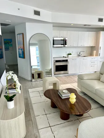 a view of a livingroom with furniture and a flat screen tv