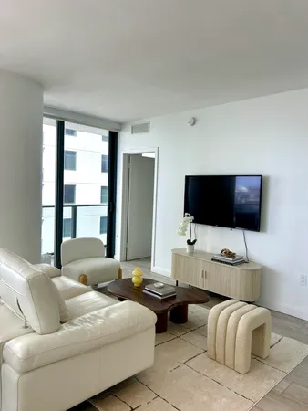 a living room with furniture and a large window