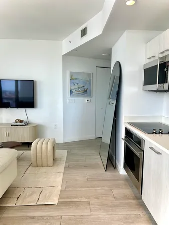 a living room with furniture and a floor to ceiling window