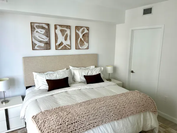 a bedroom with a bed and a cabinet