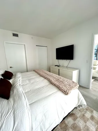 a bedroom with a bed and wall painting
