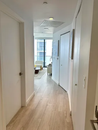 a living room with furniture a flat screen tv and a potted plant