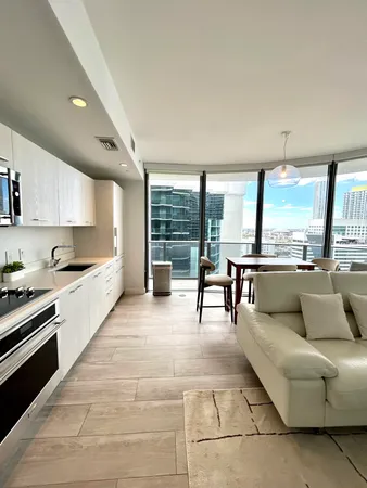 a living room with furniture and a floor to ceiling window