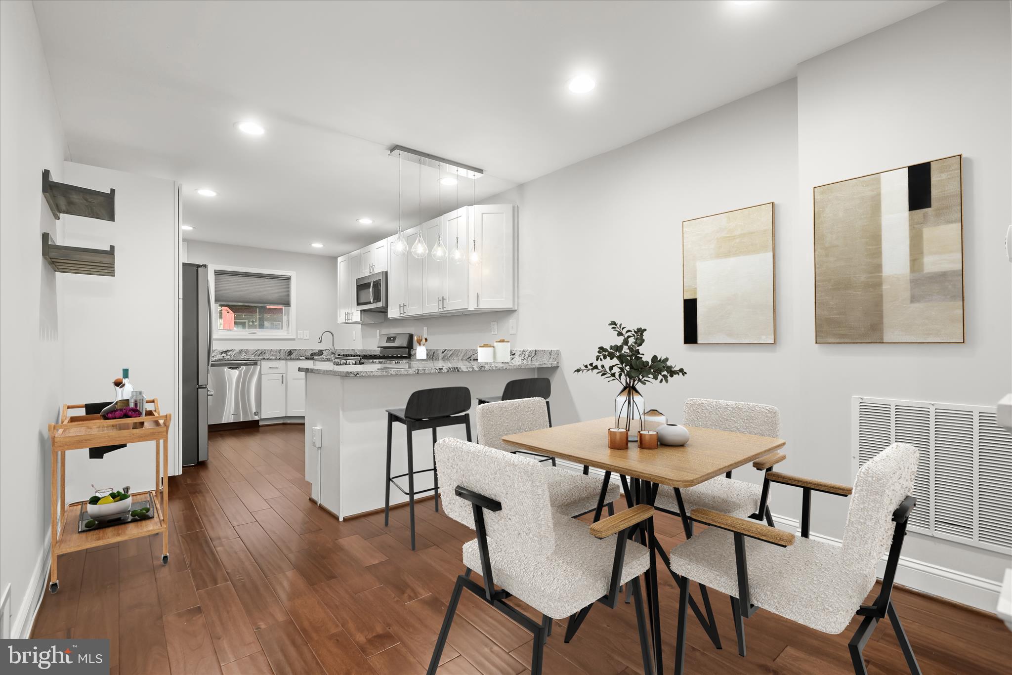 a view of a dining room with furniture and wooden floor