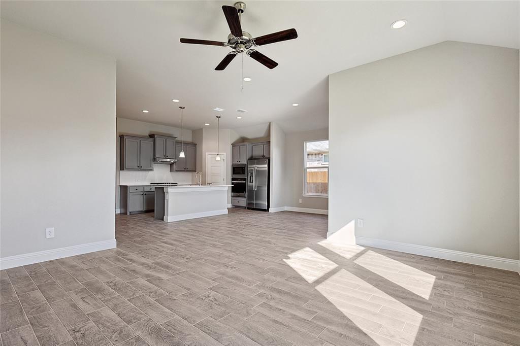 2217 Yellowhammer Road Denton, TX 76205 - Photo 20 of 30 a view of a kitchen with a sink and a refrigerator