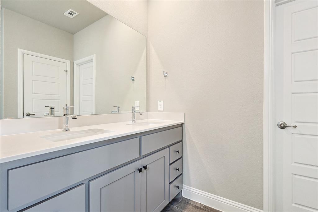 2217 Yellowhammer Road Denton, TX 76205 - Photo 24 of 30 a bathroom with a sink and a mirror