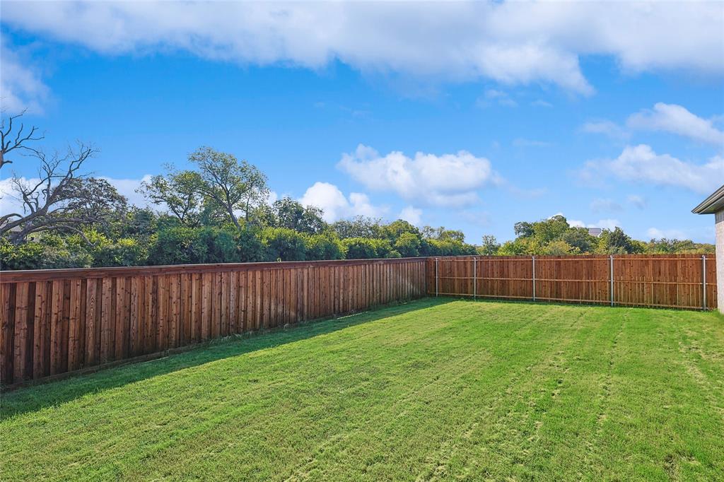 2217 Yellowhammer Road Denton, TX 76205 - Photo 29 of 30 a view of a yard with wooden fence