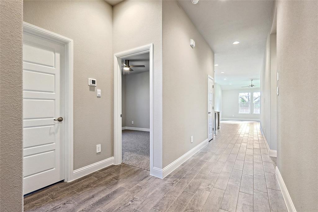 2217 Yellowhammer Road Denton, TX 76205 - Photo 6 of 30 a view of a hallway with wooden floor
