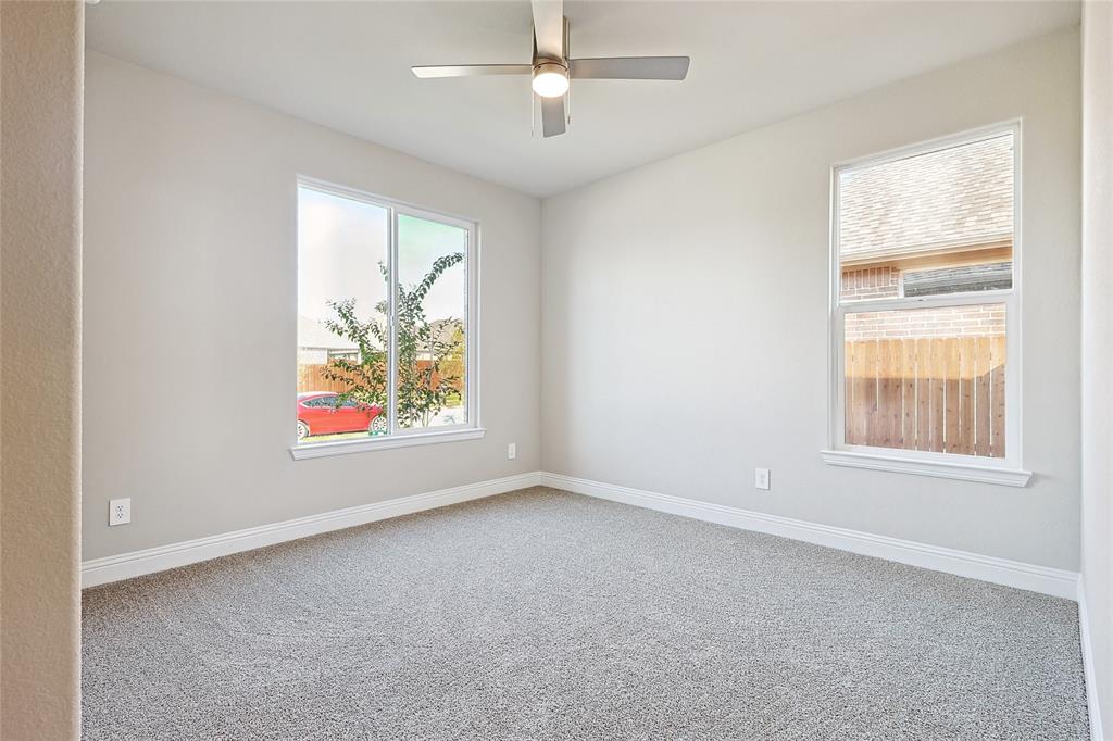2217 Yellowhammer Road Denton, TX 76205 - Photo 8 of 30 an empty room with windows and a ceiling fan