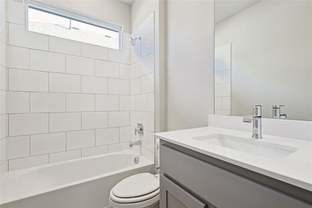 2217 Yellowhammer Road Denton, TX 76205 - Photo 9 of 30 a bathroom with a sink a toilet and bathtub