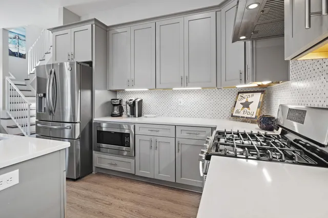 a kitchen with a refrigerator and a stove