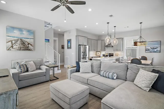 a living room with furniture and kitchen view