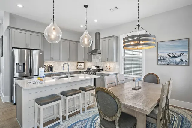 a kitchen with cabinets a center island and stainless steel appliances