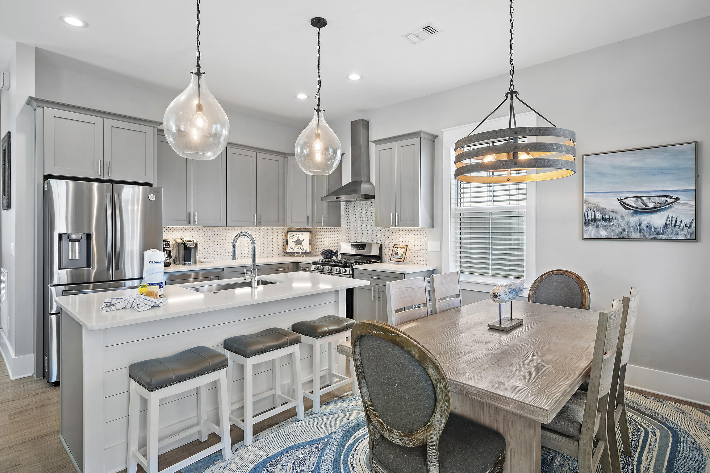 459 Dolphin Drive Santa Rosa Beach, FL 32459 - Photo 7 of 31 a kitchen with cabinets a center island and stainless steel appliances
