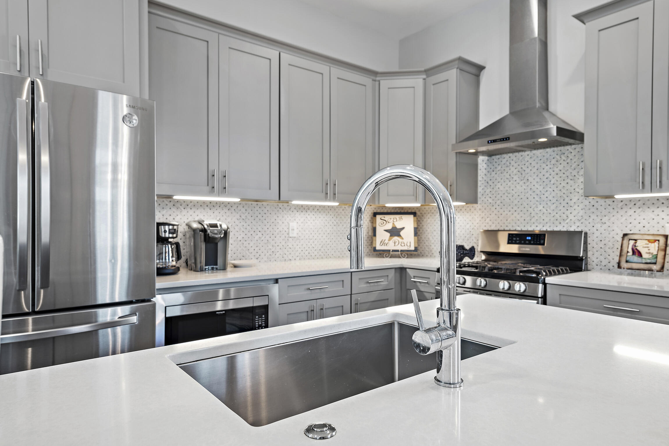 459 Dolphin Drive Santa Rosa Beach, FL 32459 - Photo 10 of 31 a kitchen with stainless steel appliances granite countertop a refrigerator a stove and white cabinets with wooden floor