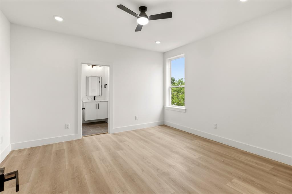 415 North Patton Avenue Dallas, TX 75203 - Photo 16 of 20 This room features light wood-style flooring, white walls, and a ceiling fan