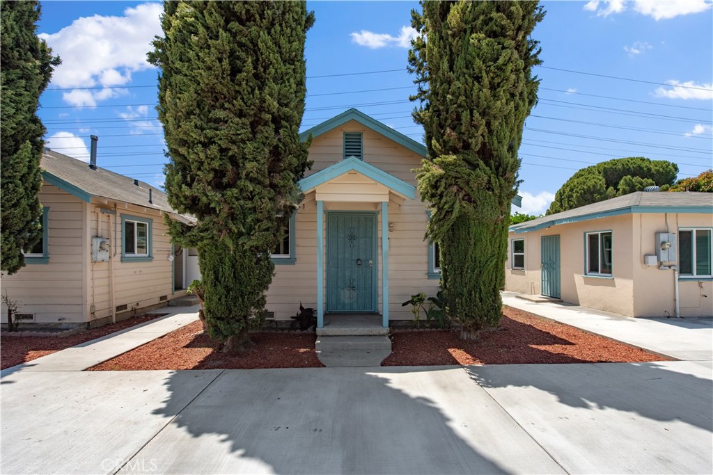 8713 Alondra Boulevard Paramount, CA 90723 - Photo 12 of 41 a front view of a house with yard