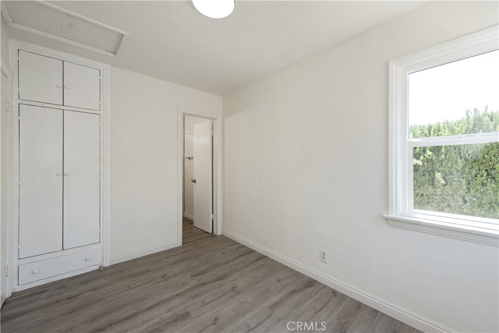 8713 Alondra Boulevard Paramount, CA 90723 - Photo 18 of 41 a view of an empty room with wooden floor and a window