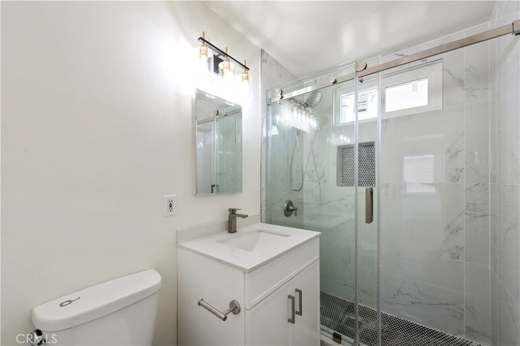 8713 Alondra Boulevard Paramount, CA 90723 - Photo 19 of 41 a bathroom with a sink a toilet and shower