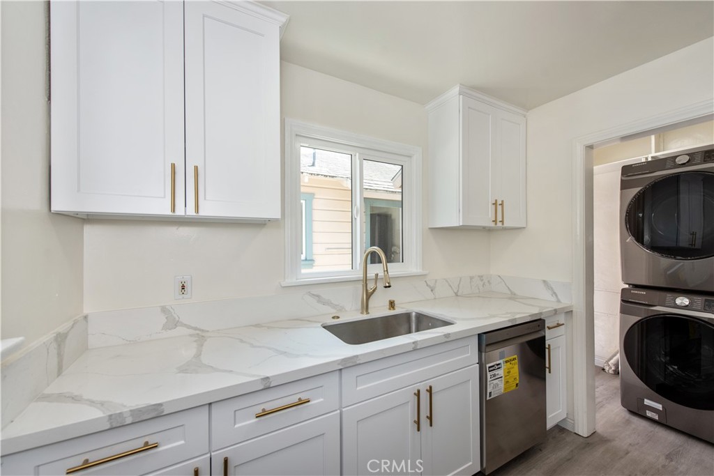 8713 Alondra Boulevard Paramount, CA 90723 - Photo 21 of 41 a kitchen with appliances a sink and cabinets